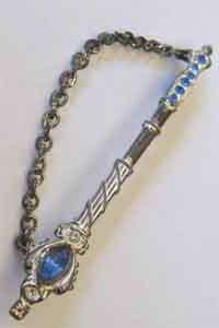 Metal Brooch with blue stones.