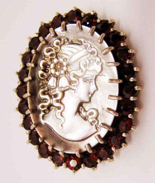 Beautiful Sterling Silver , Cameo and Garnets Brooch .
