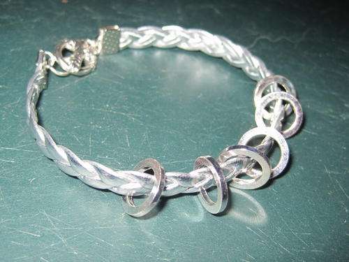 Soft silver plaited leather bracelet, with circles.