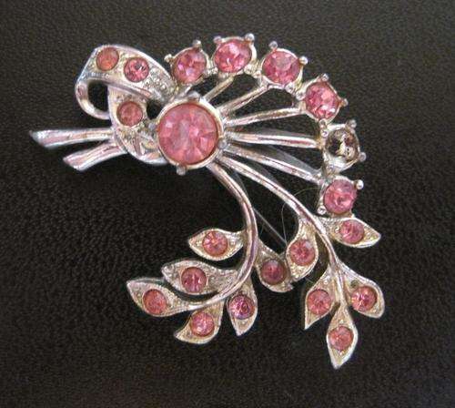 Silvertone brooch with pink stones.