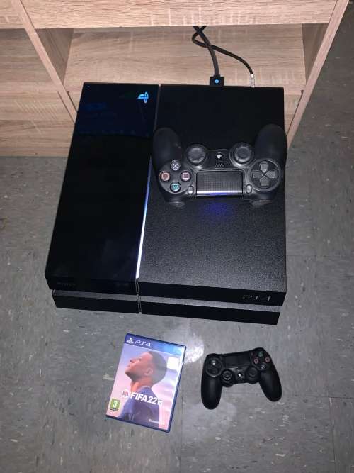 Playstation 4 Console with 2 controllers and fifa 2022.. everything is working