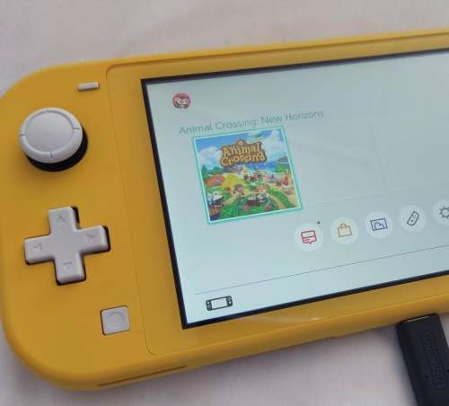 Nintendo Switch lite, charger and original packaging one digital game animal crossing new horizon