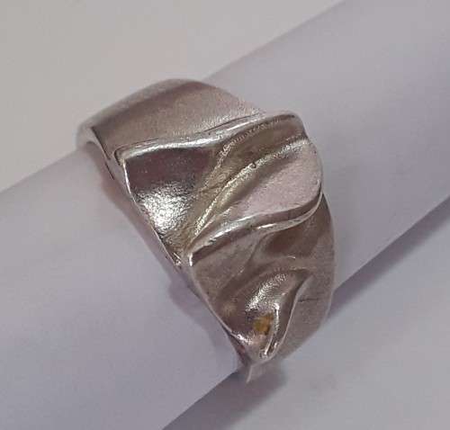 A designer solid sterling silver `folded` ring with maker`s mark. Stamped 925.