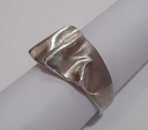 A designer solid sterling silver `folded` ring with maker`s mark. Stamped 925.