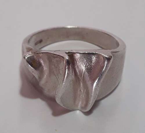A designer solid sterling silver `folded` ring with maker`s mark. Stamped 925.