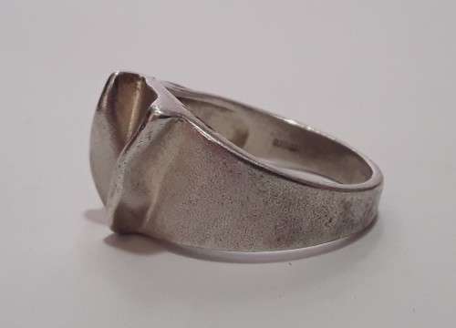 A designer solid sterling silver `folded` ring with maker`s mark. Stamped 925.