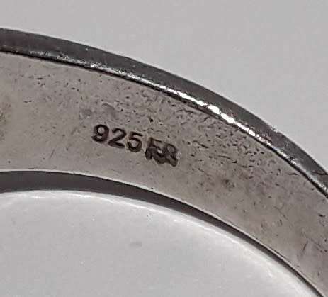 A designer solid sterling silver `folded` ring with maker`s mark. Stamped 925.