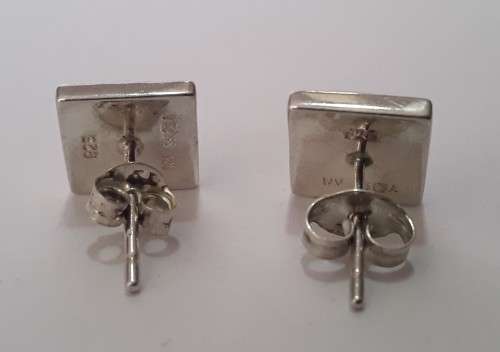 A designer pair of solid sterling silver earrings with blushing pink stones. Dainty and gorgeous!