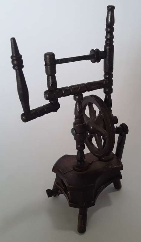 A vintage, collectable metal spinning wheel pencil sharpener.