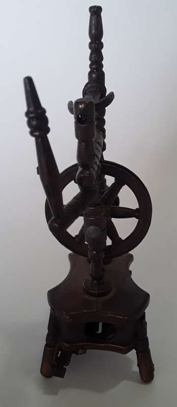 A vintage, collectable metal spinning wheel pencil sharpener.