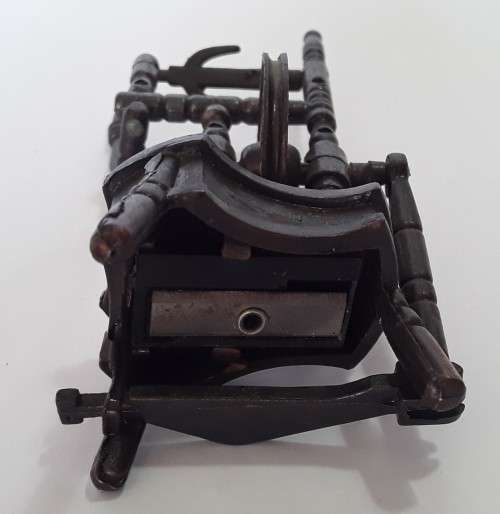 A vintage, collectable metal spinning wheel pencil sharpener.