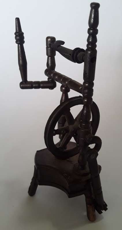 A vintage, collectable metal spinning wheel pencil sharpener.