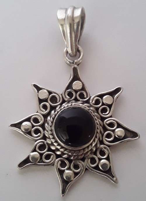 A vintage solid sterling silver and enamel star pendant.
