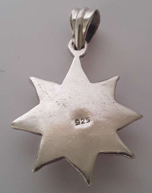 A vintage solid sterling silver and enamel star pendant.