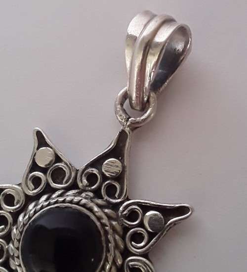 A vintage solid sterling silver and enamel star pendant.