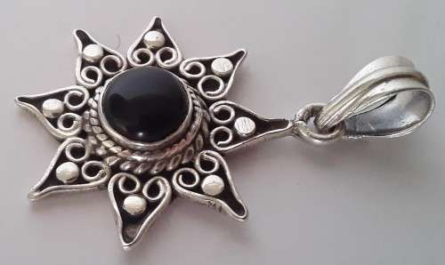 A vintage solid sterling silver and enamel star pendant.