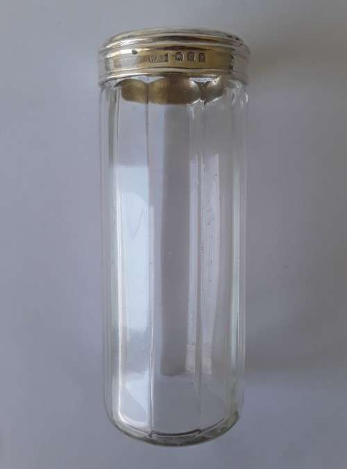 A solid sterling silver and glass bottle by `William Amaziah Ellwick`. London, 1918.
