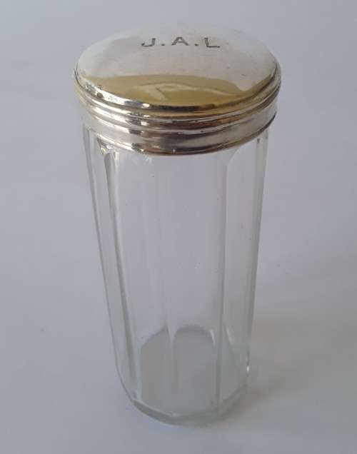 A solid sterling silver and glass bottle by `William Amaziah Ellwick`. London, 1918.