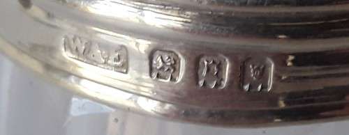 A solid sterling silver and glass bottle by `William Amaziah Ellwick`. London, 1918.