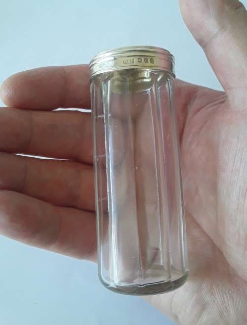 A solid sterling silver and glass bottle by `William Amaziah Ellwick`. London, 1918.