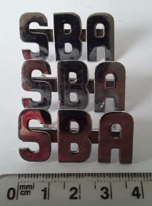 3 x SBA metal shoulder titles. Lugs intact.