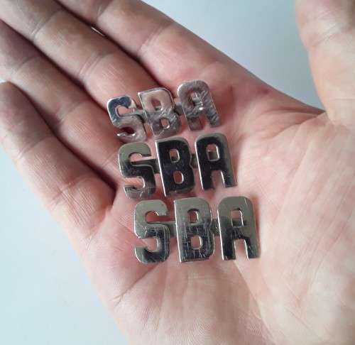 3 x SBA metal shoulder titles. Lugs intact.
