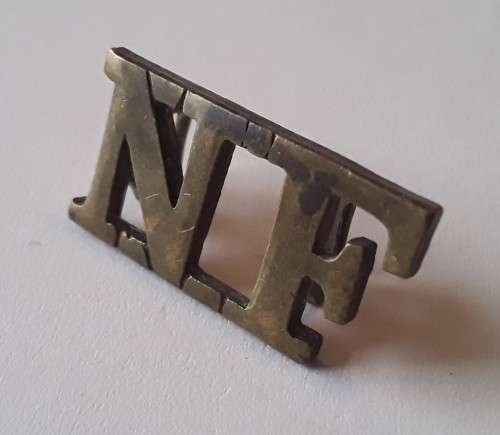 Early `Northumberland Fusiliers` Brass Shoulder Title. Lugs intact.