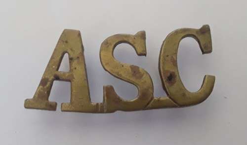 WW1 British Army Service Corps Brass Shoulder Title.  Lugs Intact.