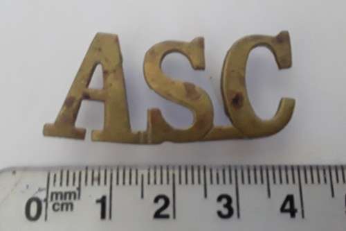 WW1 British Army Service Corps Brass Shoulder Title.  Lugs Intact.