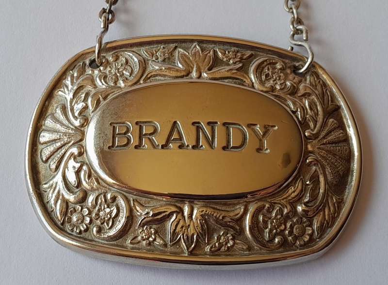 A Vintage Silver Plated `BRANDY` Bottle Decanter Label By `Ianthe, England`.