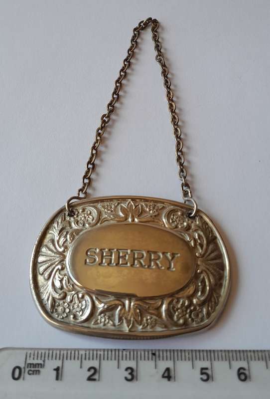 A Vintage Silver Plated `SHERRY` Bottle Decanter Label By `Ianthe, England`.