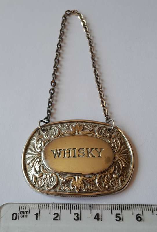 A Vintage Silver Plated `WHISKY` Bottle Decanter Label By `Ianthe, England`.
