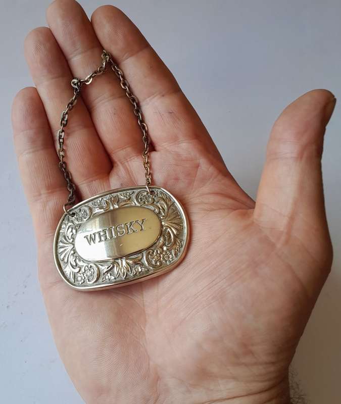A Vintage Silver Plated `WHISKY` Bottle Decanter Label By `Ianthe, England`.