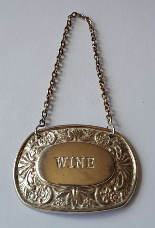 A Vintage Silver Plated `WINE` Bottle Decanter Label By `Ianthe, England`. (1 of 2).