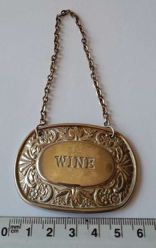 A Vintage Silver Plated `WINE` Bottle Decanter Label By `Ianthe, England`. (2 of 2)