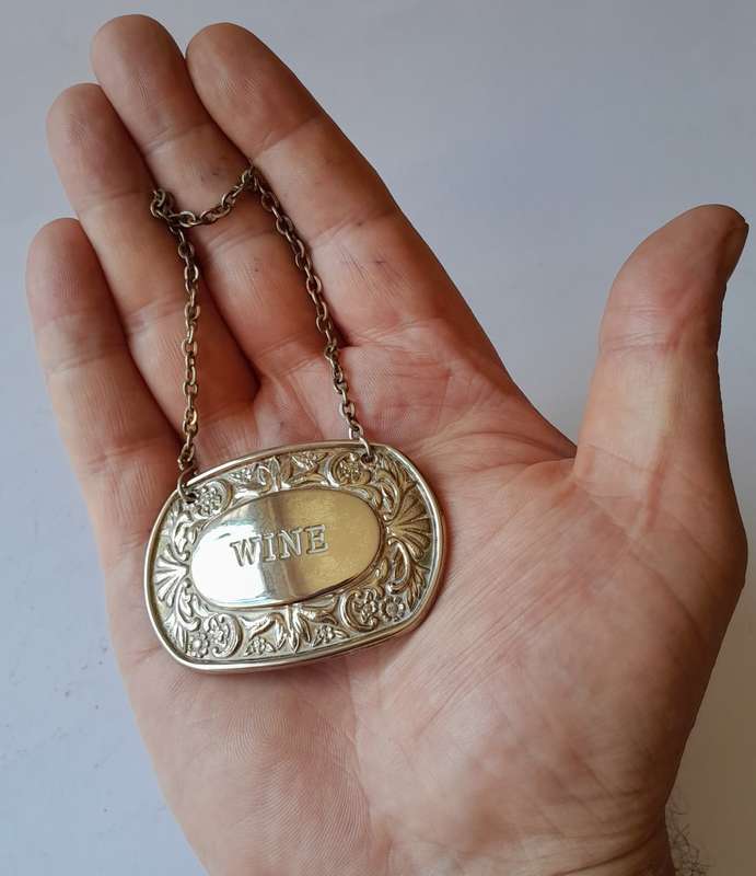 A Vintage Silver Plated `WINE` Bottle Decanter Label By `Ianthe, England`. (2 of 2)
