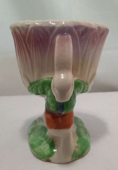 Nostalgic vintage porcelain petal vase held by two bunnies