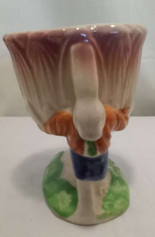 Nostalgic vintage porcelain petal vase held by two bunnies