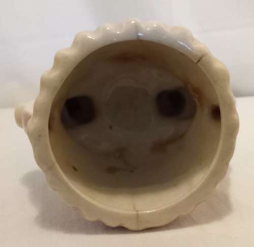 Nostalgic vintage porcelain petal vase held by two bunnies