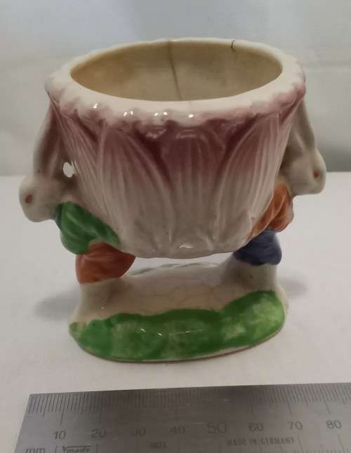 Nostalgic vintage porcelain petal vase held by two bunnies