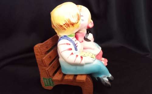 Cutest vintage kissing couple on wooden bench by Balboa