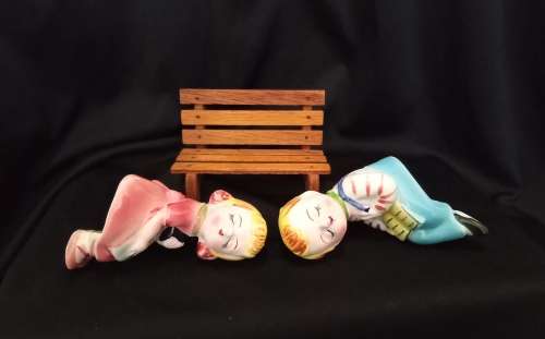 Cutest vintage kissing couple on wooden bench by Balboa
