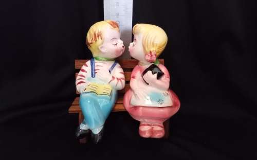 Cutest vintage kissing couple on wooden bench by Balboa