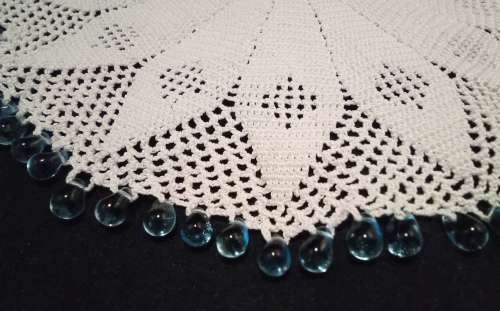 White Vintage crocheted jug cover with turquoise glass beads