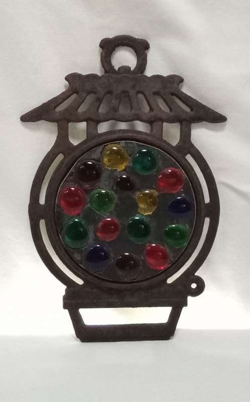 Vintage cast iron Trivet with glass  pebbles