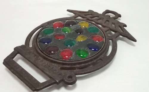 Vintage cast iron Trivet with glass  pebbles