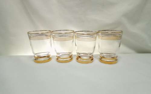Four beautiful vintage gold rimmed little drinking glasses
