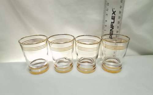 Four beautiful vintage gold rimmed little drinking glasses