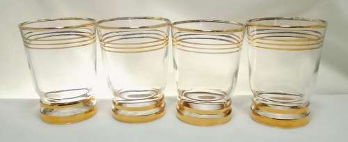 Four beautiful vintage gold rimmed little drinking glasses