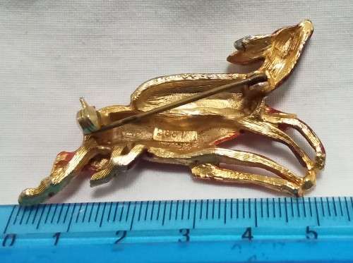 Beautiful vintage gold coloured brooch with two enameled leaping deer